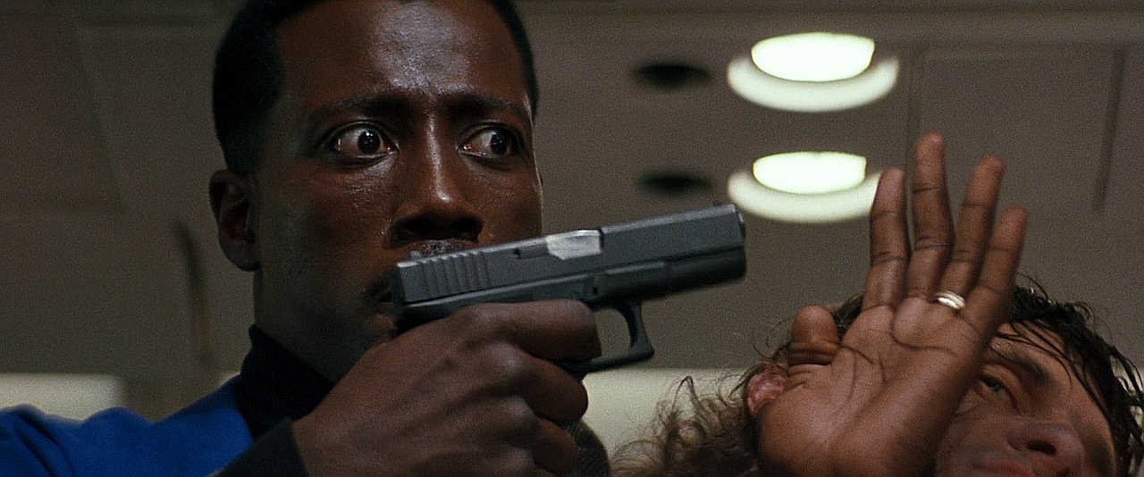 In this scene from Passenger 57 we can see that the Glock’s barrel has been modified to remove its lock up, in order to shoot blanks in the pistol
