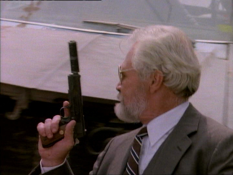In "The Golden Triangle" (S1E02), a Junkyard goon with a Colt Mk IV Series 70.